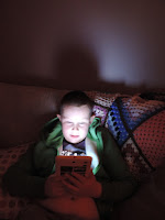kid playing dragon quest on tablet