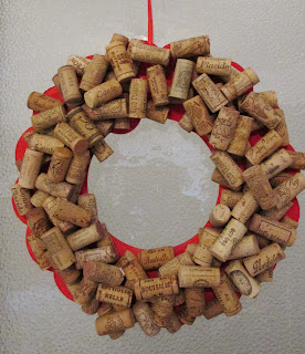 14 in diameter red painted cardboard wreath covered in 45 wine corks