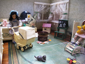 One-twelfth scale miniature 1940s child's bedroom with two girl dolls in it.