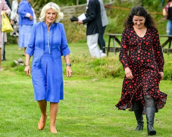 Duchess of Cornwall, Patron of Community First, visited Oxenwood Outdoor Education Centre. She wore a blue summer dress and pearl earrings