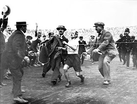 Pietri is helped across the line at the finish of the race