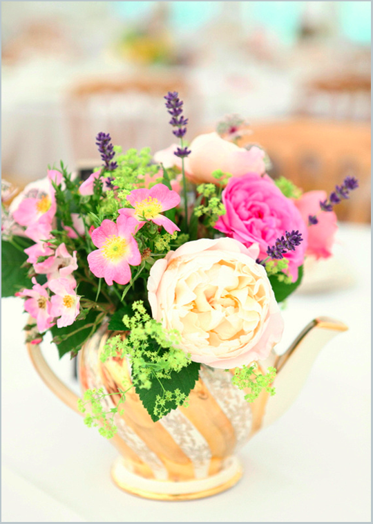 flowers in a gold and white vintage teapot
