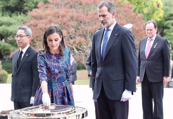 Queen Letizia wore Temperley London Eggshell floral embroidery tulle midi dress and Hugo Boss Dadoria beltedsheath dress