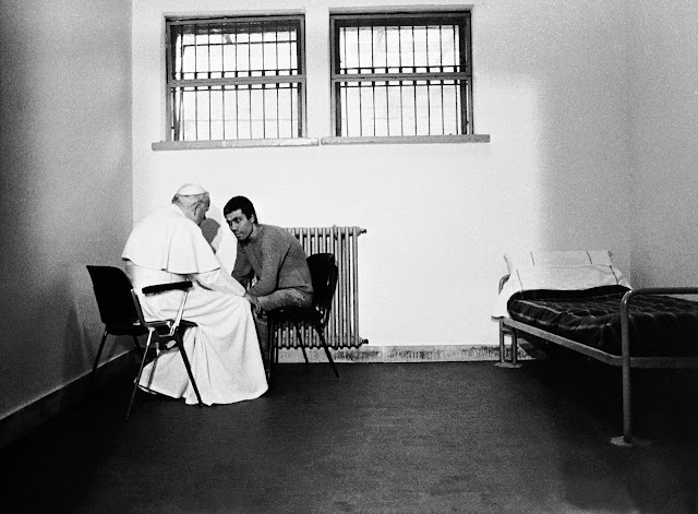 Pope John Paul II visits his would-be assassin Mehmet Ali Ağca in prison.
