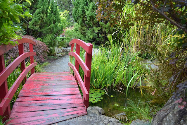 Red foot bridge leads us into the Japanese Gardens