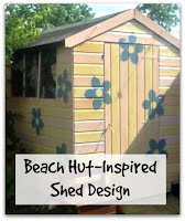 Beach Hut-Inspired Shed Design A Pink and Yellow Striped Shed with Large Blue Painted Flowers