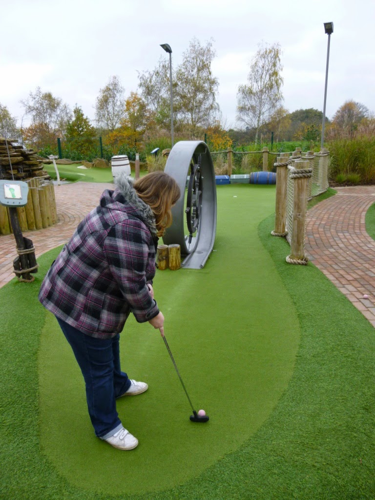 Helen plays a shot on the BIG minigolf loop-di-loop at Pirate Island Adventure Golf course at Hoebridge Golf Centre in Woking, Surrey Pirate Island Adventure Golf course at Hoebridge Golf Centre in Woking, Surrey