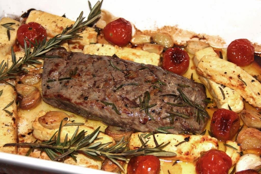 Lamb Roasted with Rosemary, Feta, Tomatoes and Garlic