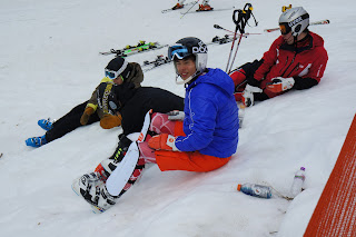 skiers sitting on slope photo