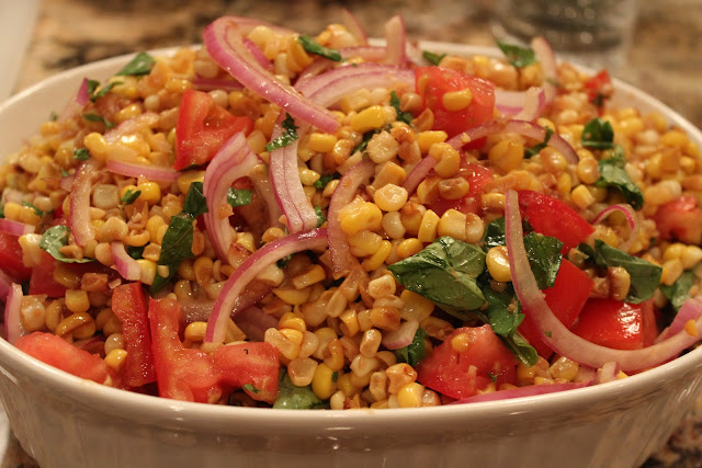 Corn salad with basil, tomatoes, and red onion