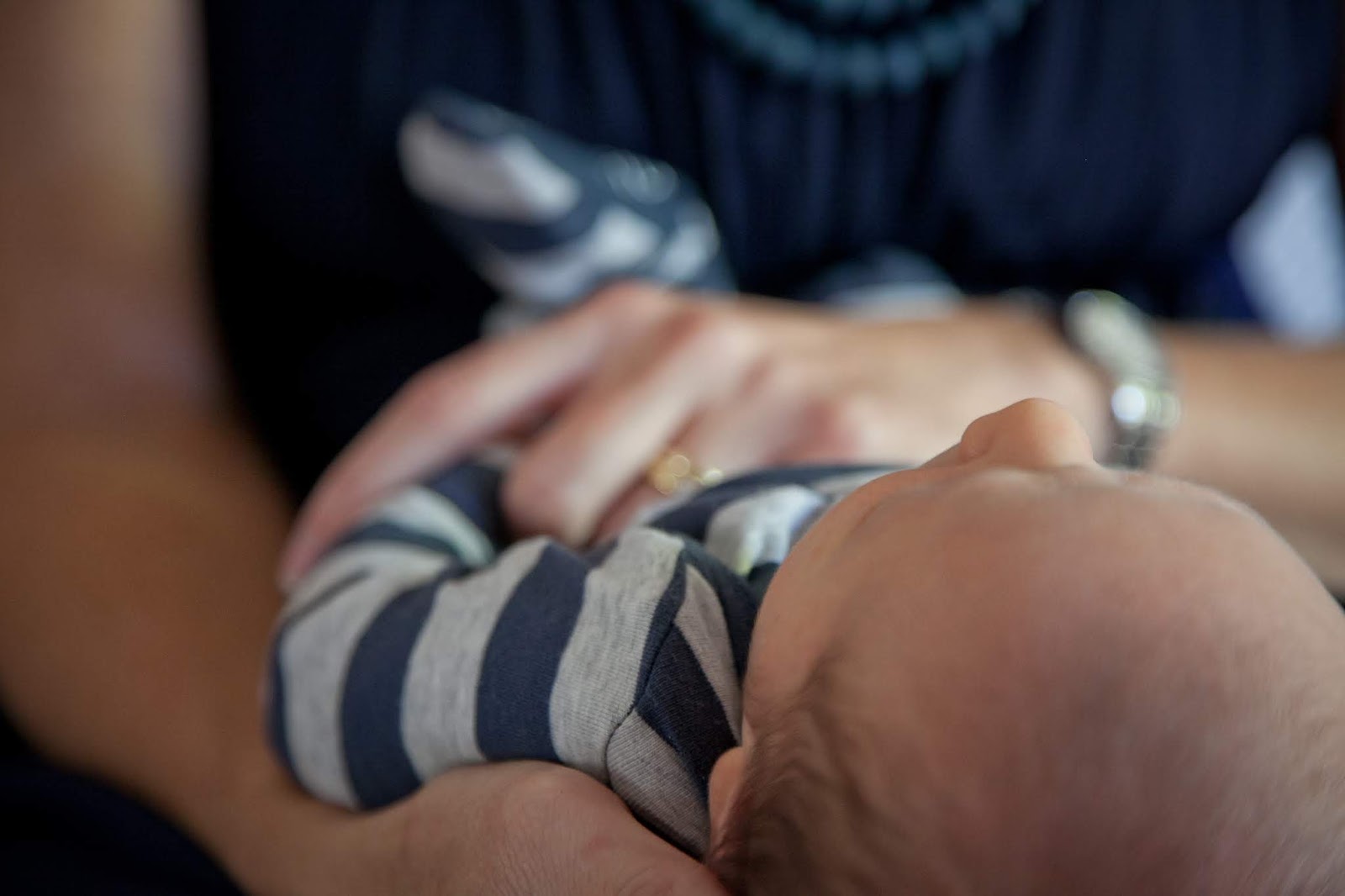 NAMC montessori parenting with a disability close up holding a baby