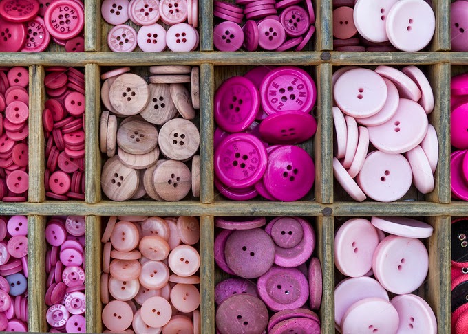 Pink buttons arranged in a drawer