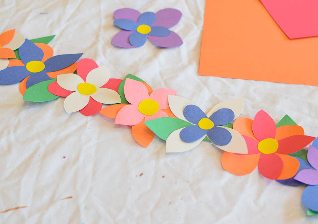 Flower Crowns- great easy spring craft for preschool, kindergarten, or elementary kids. Work on fine motor skills while making pretty flower crowns with just a few simple materials!