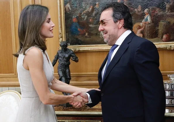 Queen Letizia wore Adolfo Dominguez wrap dress with frayed edges and she wore carolina herrera suede pumps