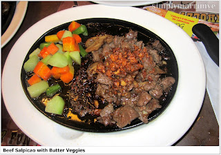 Tender beef cubes with lots of sauteed minced garlic and flavored sauce with buttered veggies on the side
