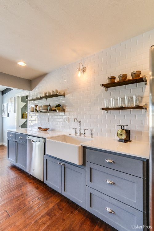 Blue and white #modernfarmhouse kitchen with open shelving and apron front farm sink.
