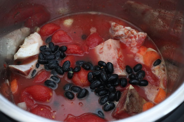 adding in soaked black beans to the instant pot soup