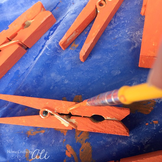 Touching up paint on dried clothespins