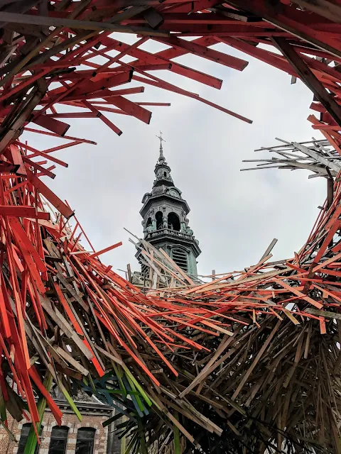 Sainte-Elizabeth church viewed through the Mons Belgium European Capital of Culture wooden art installation