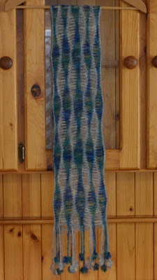 Silk mohair scarf in blue-green and silver-grey wavy patterns along the length of the scarf and finished with decorative fringe.