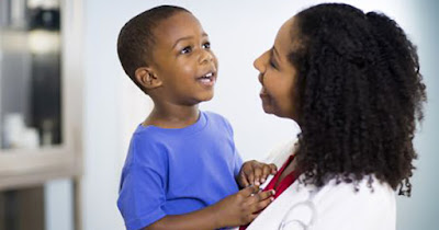 Doctor with African American autistic boy