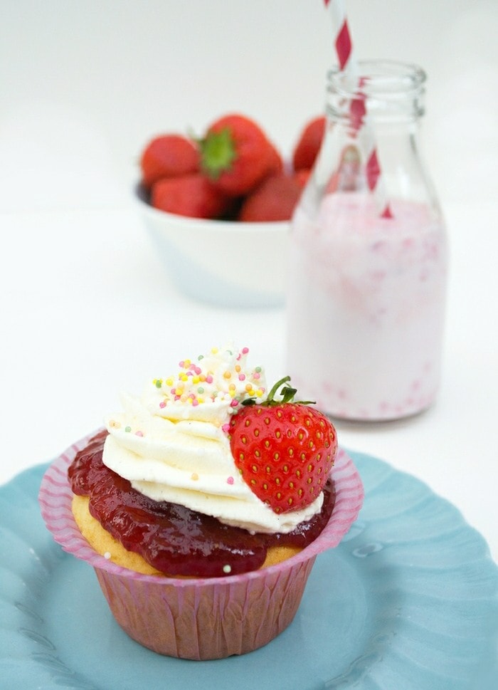 Old-Fashioned Strawberry and Vanilla Fairy Cakes with Sprinkles Old-Fashioned Strawberry and Vanilla Fairy Cakes with Sprinkles served with strawberry milkshake with bowl of strawberries in the background