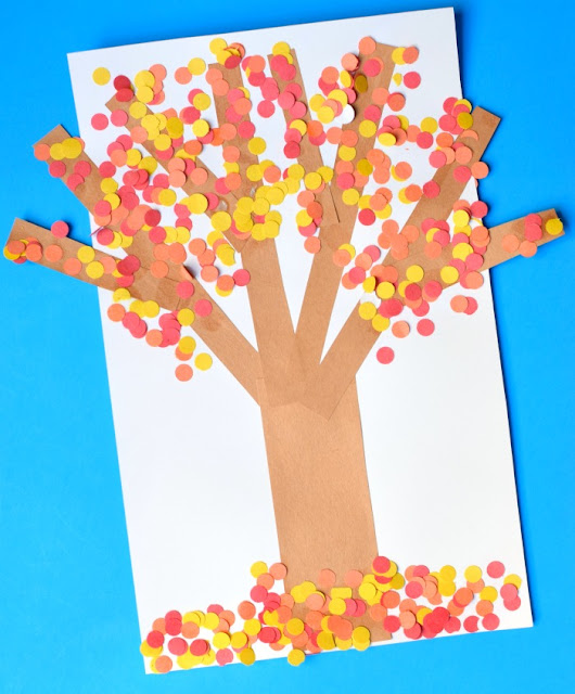 Fall tree craft for toddlers, preschoolers, or kindergartners. Use hole punch circles in red, orange, and yellow to make autumn leaves! Great fine motor work!
