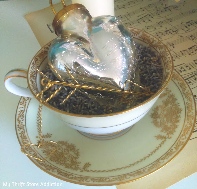 A lavender filled teacup accented with a mercury glass heart and tiny gold arrow--yes, please! Romantic Valentine mantel