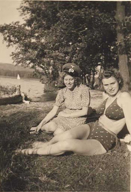 French girls. One of them is wearing a German hat.