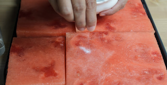 sprinkling sugar on watermelon for Watermelon and Strawberry Cake image