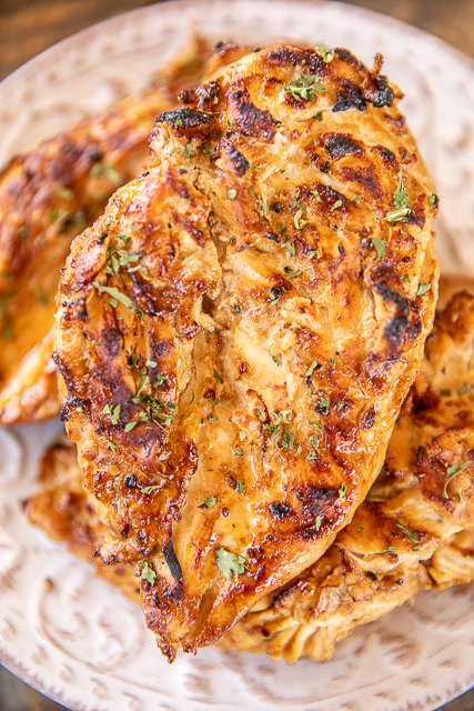 The BEST Grilled Lemon Dijon Chicken - only 6 ingredients! This chicken is seriously delicious! We ate this two days in a row! Chicken, soy sauce, dijon mustard, olive oil, Worcestershire, garlic and pepper. Marinate overnight for maximum flavor. Leftovers are great on top of a salad, tossed in pasta or in a sandwich wrap. A MUST for your next cookout! #grilling #grilledchicken #chicken #grill cooked grilled chicken on a plate