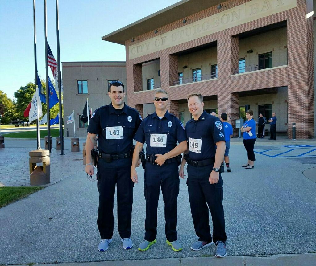 Sturgeon Bay Police Department Officers run in duty gear to honor the