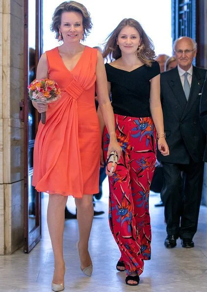Crown Princess Elisabeth wore Zara fringed coat, Maje Poplin dress, Diane von Furstenberg floral trousers, Maje Raphael dress. Queen Mathilde