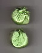 Round green fabric Christmas ornaments resemble white grapes