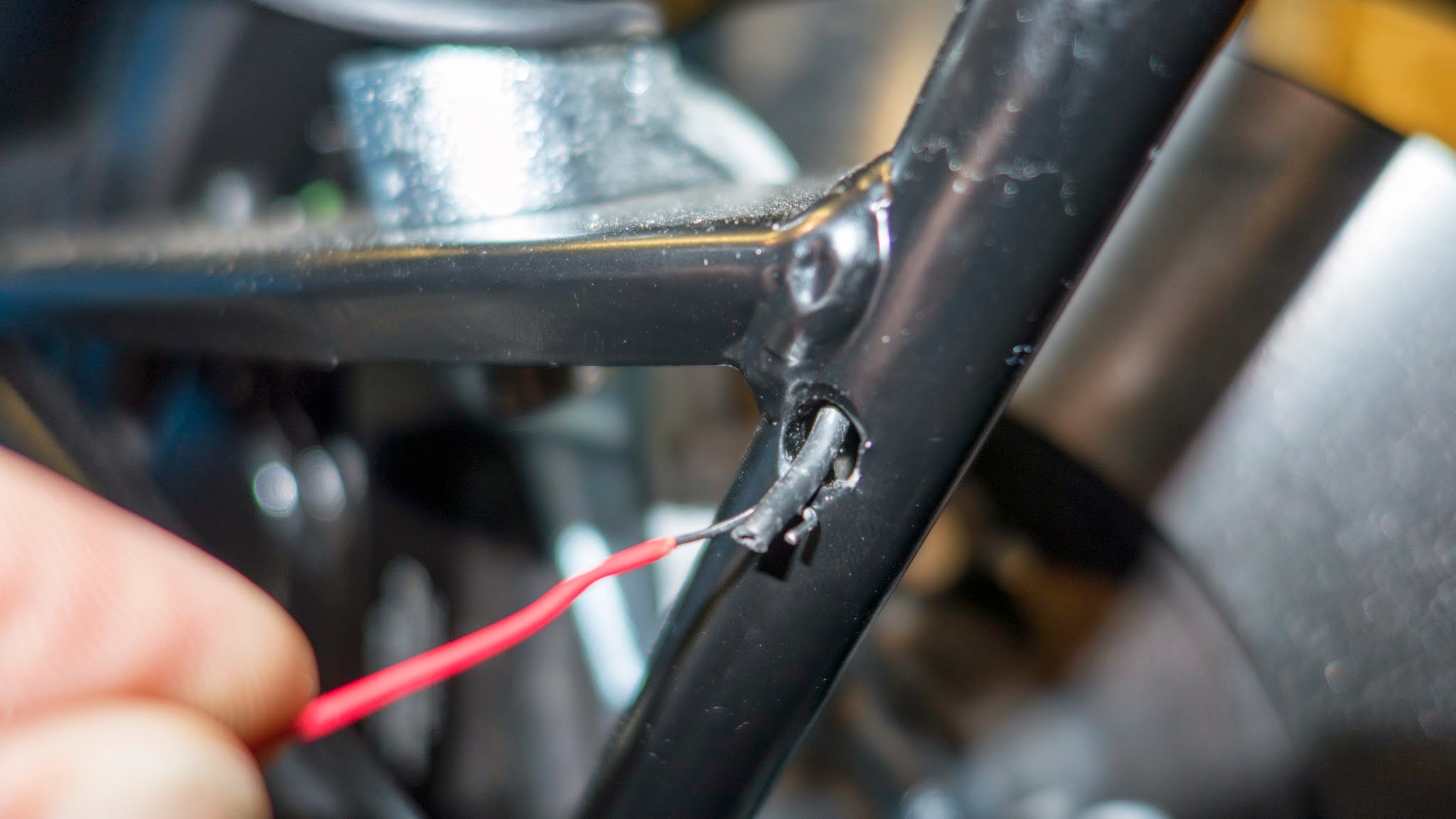 Using a paperclip to pulled cable through bottom wing stay hole. Using a paperclip to pulled cable through bottom wing stay hole.