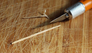 Attempting to split a toothpick with a craft knife Attempting to split a toothpick with a craft knife