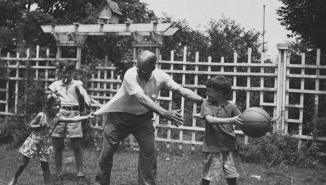 Dr. James Naismith plays basketball with his grandchildren in the backyard. Baskets and Ladders. marchmatron.com Dr. James Naismith plays basketball with his grandchildren in the backyard. Baskets and Ladders. marchmatron.com