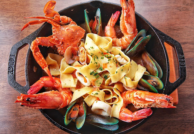 Seafood Tagliatelle with clams, mussels, prawns, squid, and tomatoes Seafood Tagliatelle with clams, mussels, prawns, squid, and tomatoes