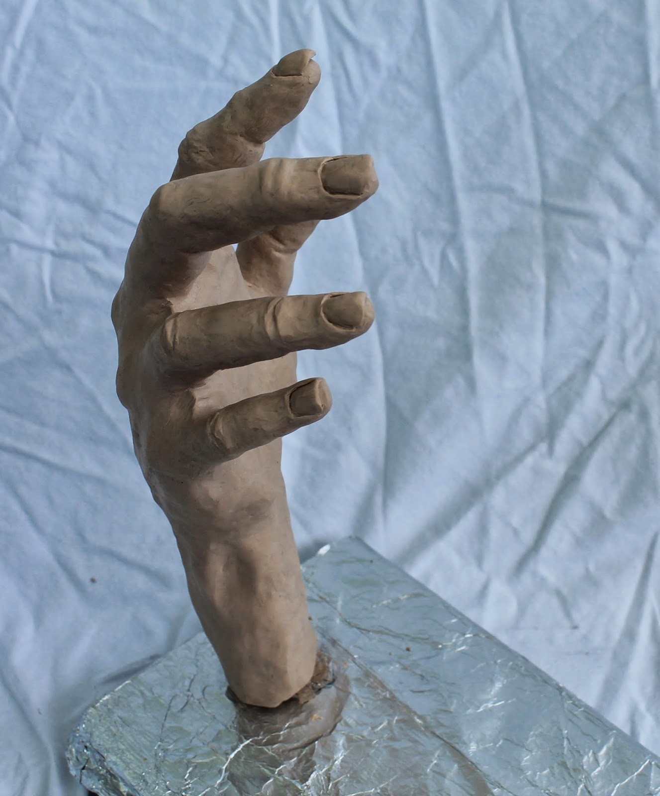 Connecting Pieces Sculpting a Hand out of Sculpy Clay The Wine Grab Sign