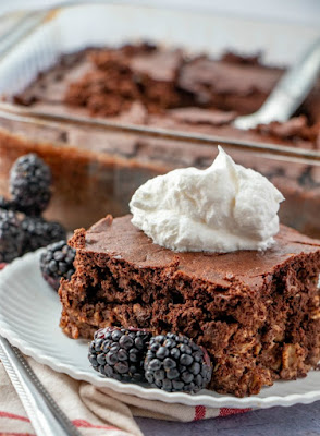 The taste of brownies is now an acceptable breakfast. It is really loaded with oatmeal and yogurt. Go ahead and make some, I dare you! piece of brownie baked oatmeal on plate with pan of remaining chocolate oatmeal in the background