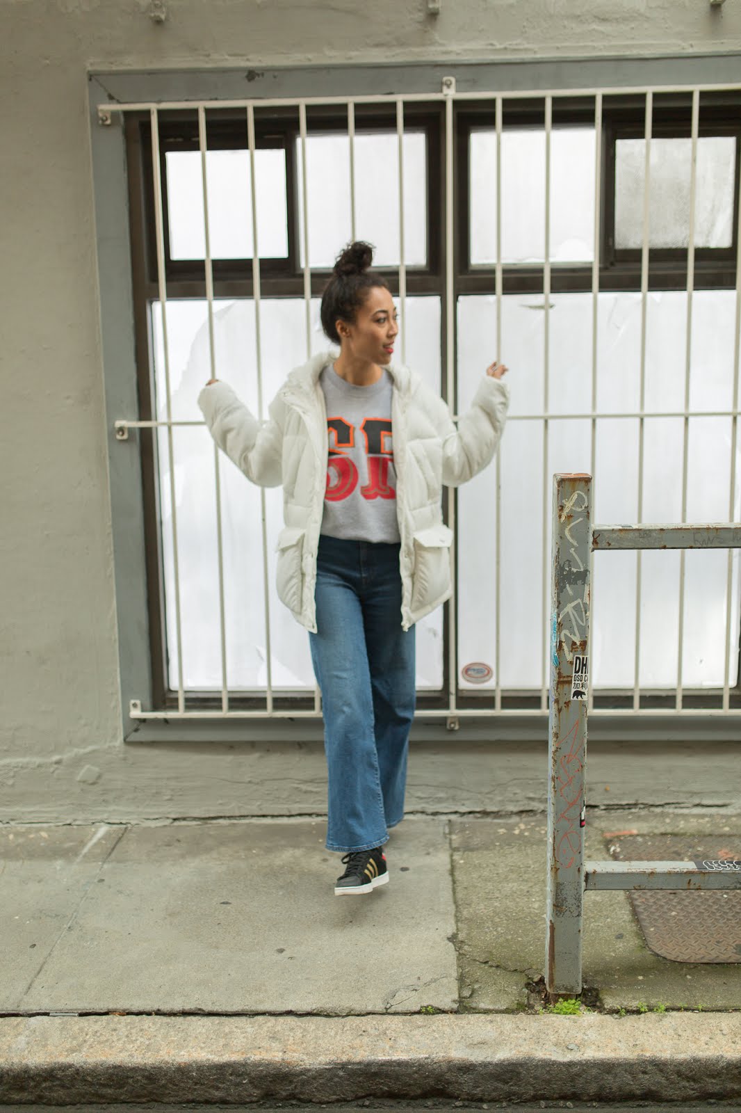 pancake stacker pancake stacker wearing a Booger Kids SF sweatshirt, Uniqlo wide leg jeans, Adidas Superstar shoes and ASOS white, puffer jacket.
