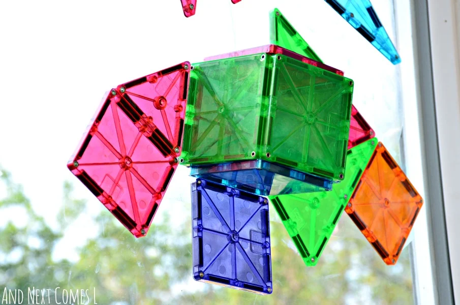 Cube made from Magna-Tiles on a window from And Next Comes L