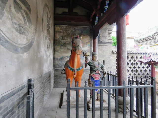 Statue of a man with horse at a temple in Pingyao, China