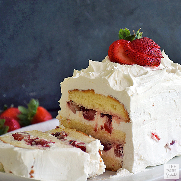 No Bake Strawberry Cake | by Life Tastes Good is perfect for summer, y'all. It is bursting with fresh, sweet strawberries sandwiched between layers of buttery cake, and all topped off with the sweet creamy goodness of whipped topping. Doesn't that sound amazing? But wait it gets better...