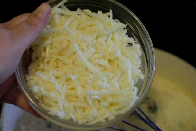 Shredded mozzarella being added to the pan.  