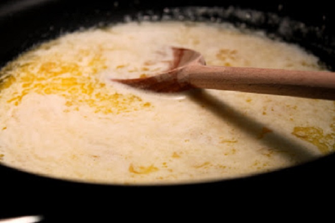 wine sauce with butter and heavy cream simmering to pour over shrimp