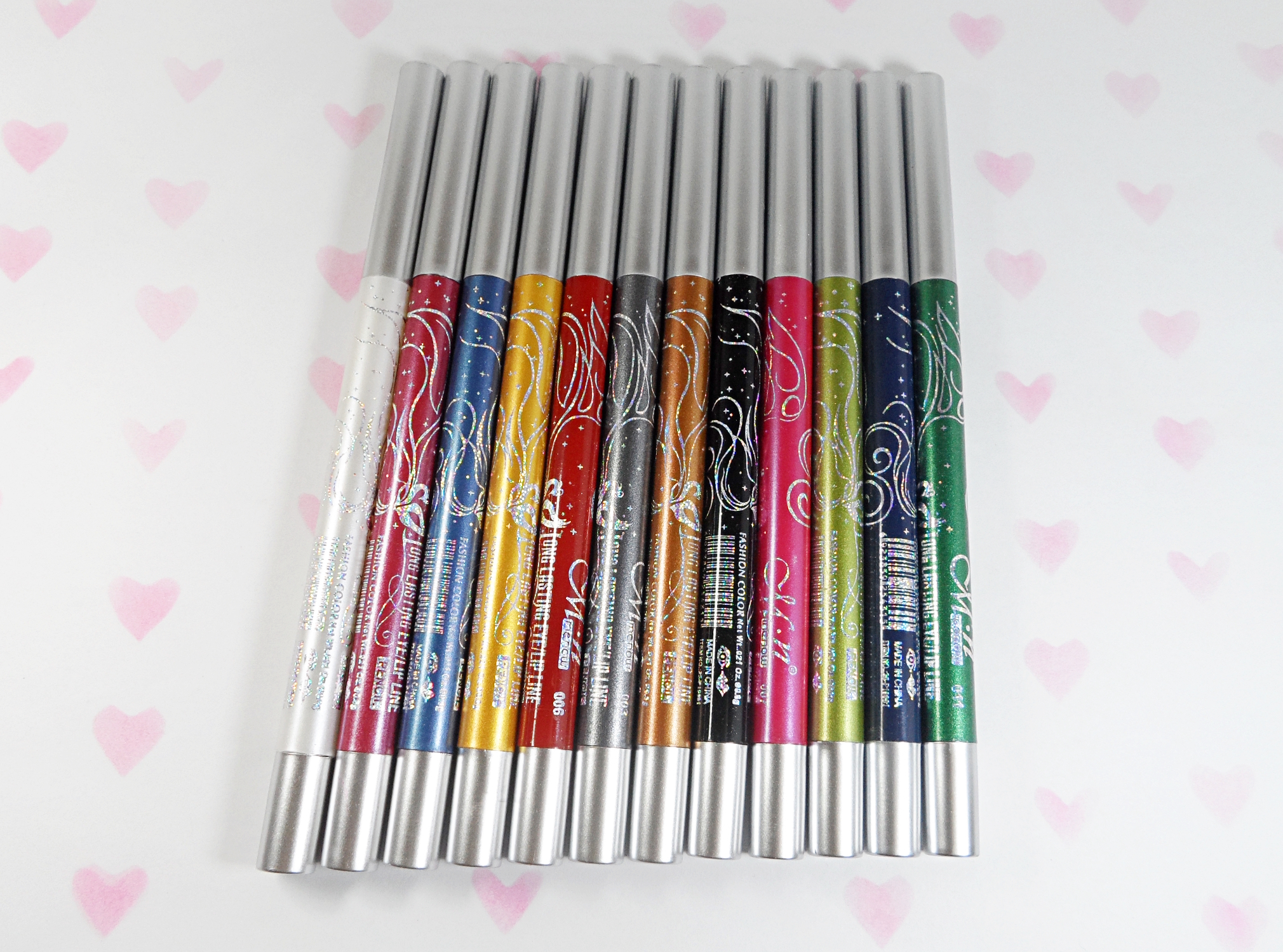 a stack of cheap, makeup pencils in a studio on a plain background