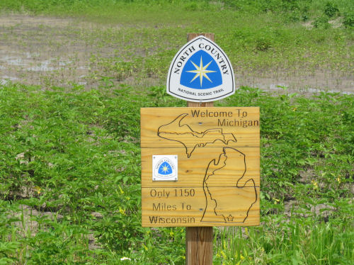 Michigan Ohio border sign on North Country Trail