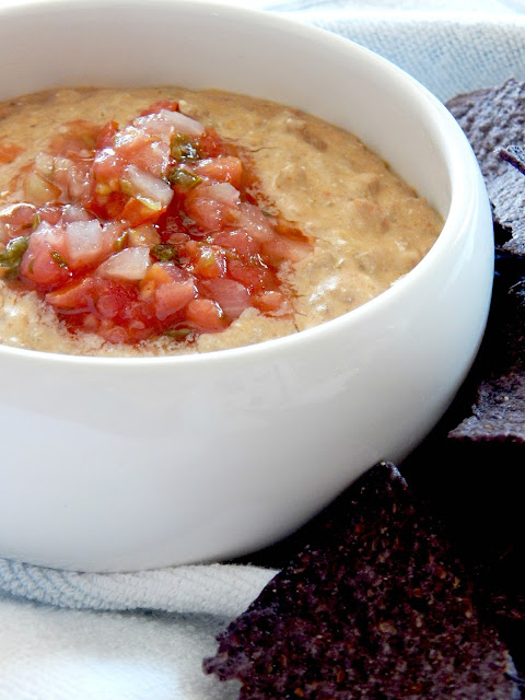 Slow Cooker Beef & Bean Dip...the easiest cheesy dip around!  Just dump and stir until melted through.  Cheesy, with taco flavor, topped with extra pico de gallo for good measure! (sweetandsavoryfood.com)