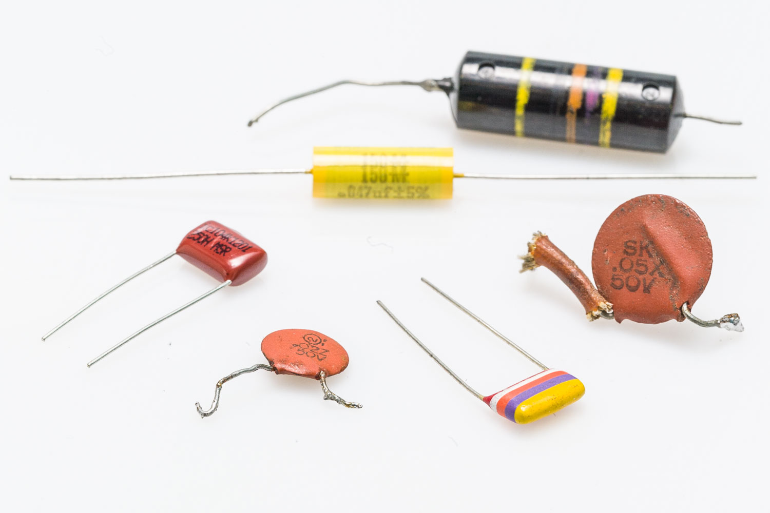 From left to right: Stock modern Fender cap, Sprague